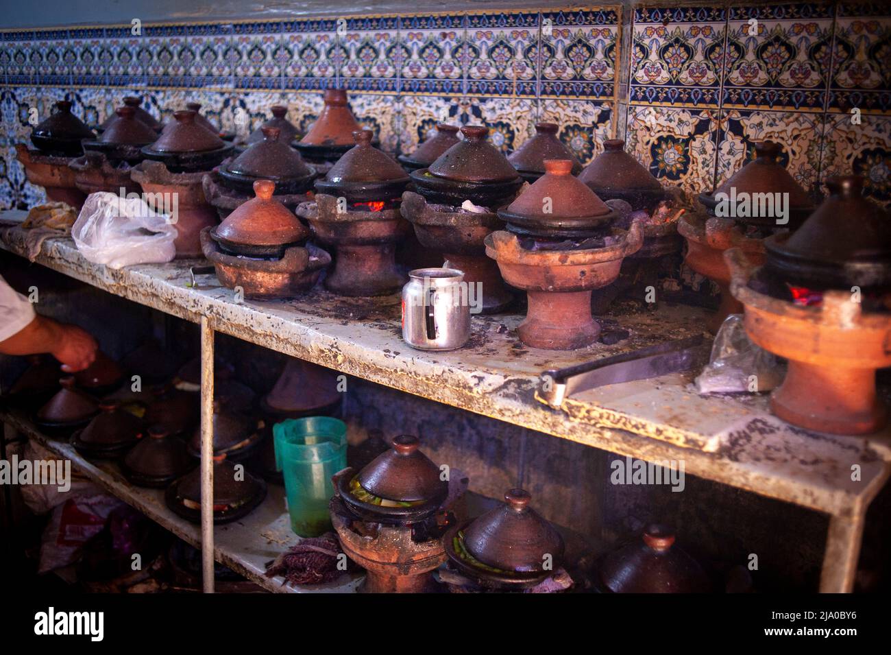 Tajine kitchen restaurant nearby Ferbantiers square. Daily life scene in the traditional Medina and zoco streets of Marrakesh, Morocco. Stock Photo