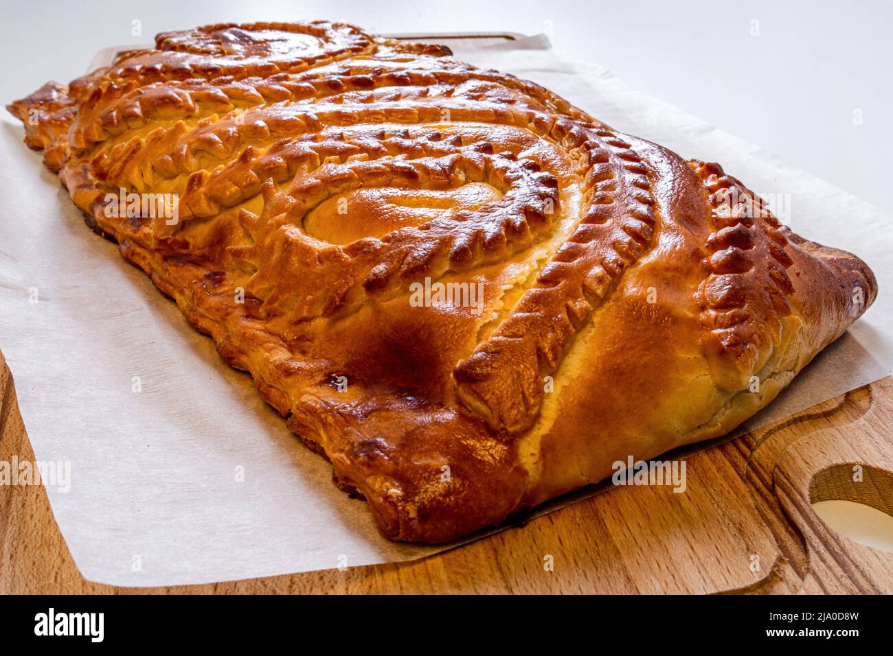 Pie with fresh meat on a wooden table close-up. Homemade cakes. Traditional Russian and Ukrainian cuisine Stock Photo