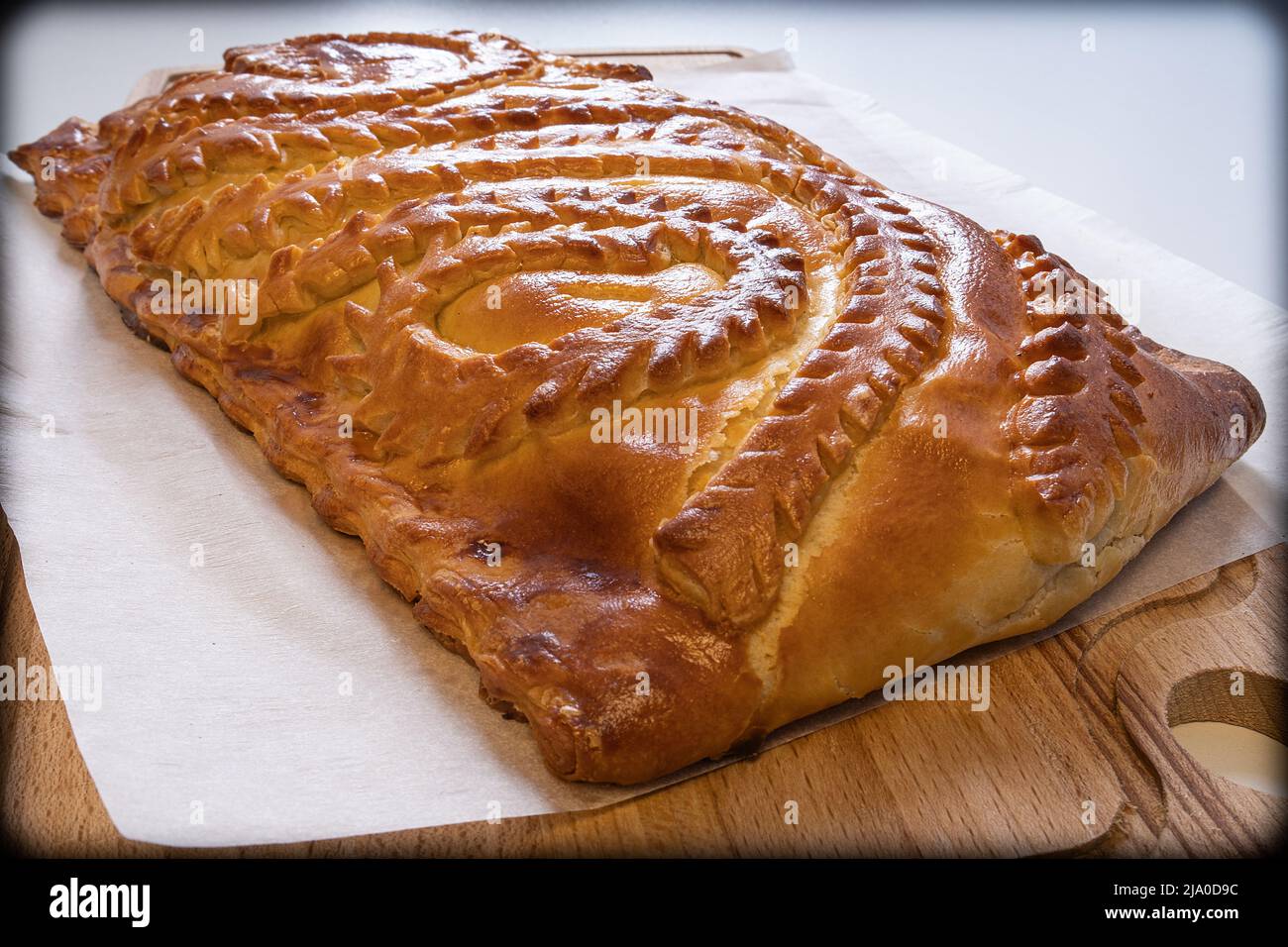 Pie with fresh meat on a wooden table close-up. Homemade cakes. Traditional Russian and Ukrainian cuisine Stock Photo