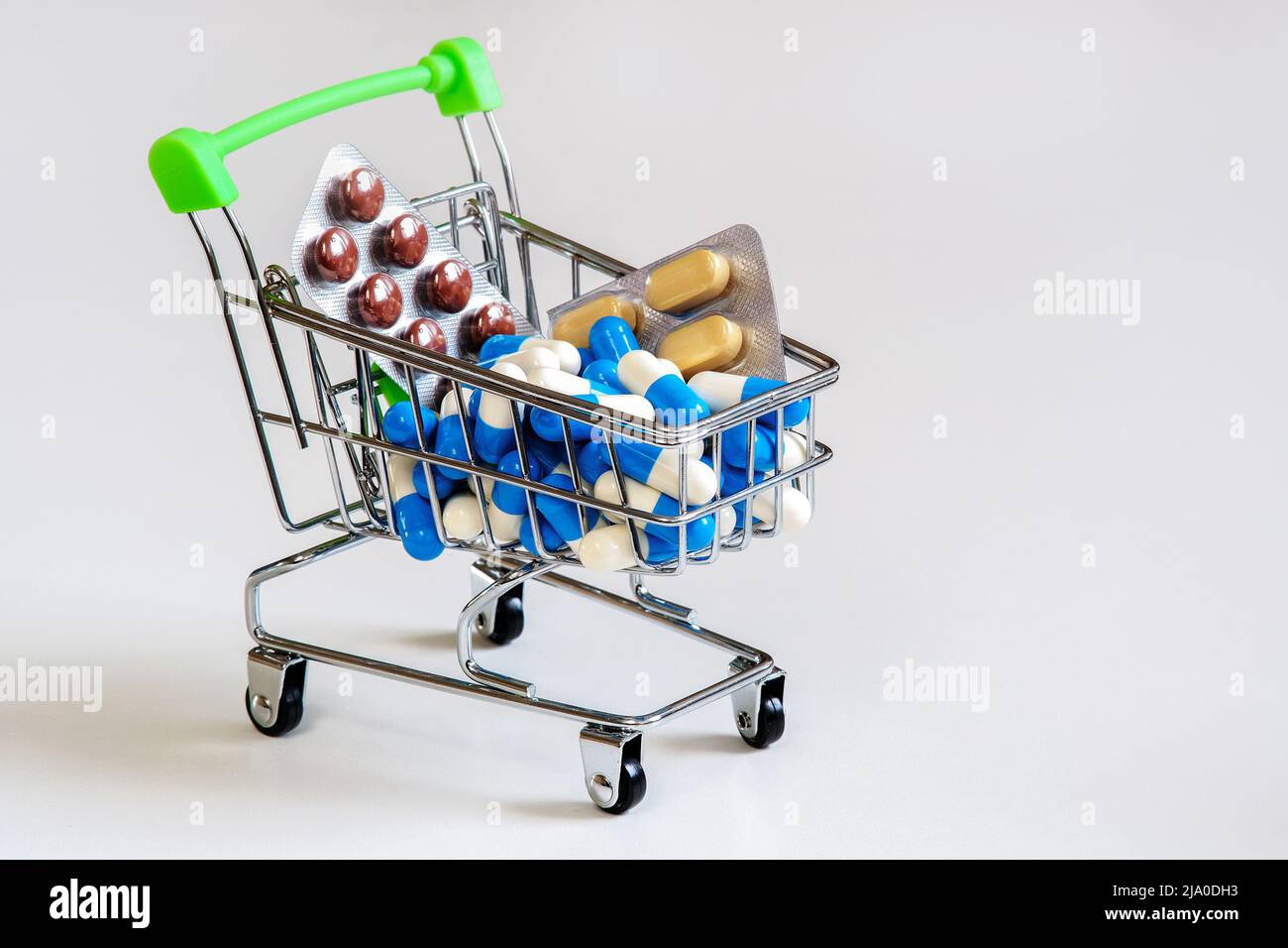 A bunch of different pills on a light background. Piling up in the shopping cart Stock Photo