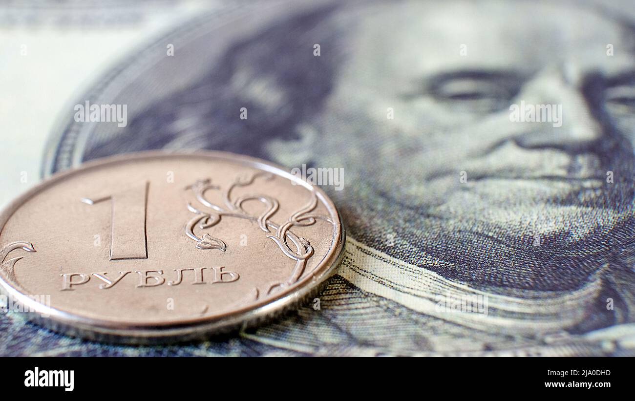 A ruble coin with a dollar bill symbolizes the fever of the economic situation, fluctuations in exchange rates Stock Photo