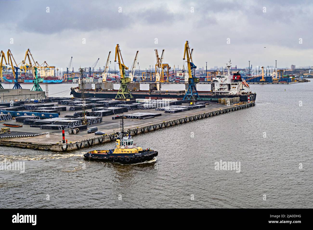 Port stacks of containers. Logistics under sanctions. Port cranes of the unloading terminal. Saint-Petersburg. Russia. April 8, 2022 Stock Photo