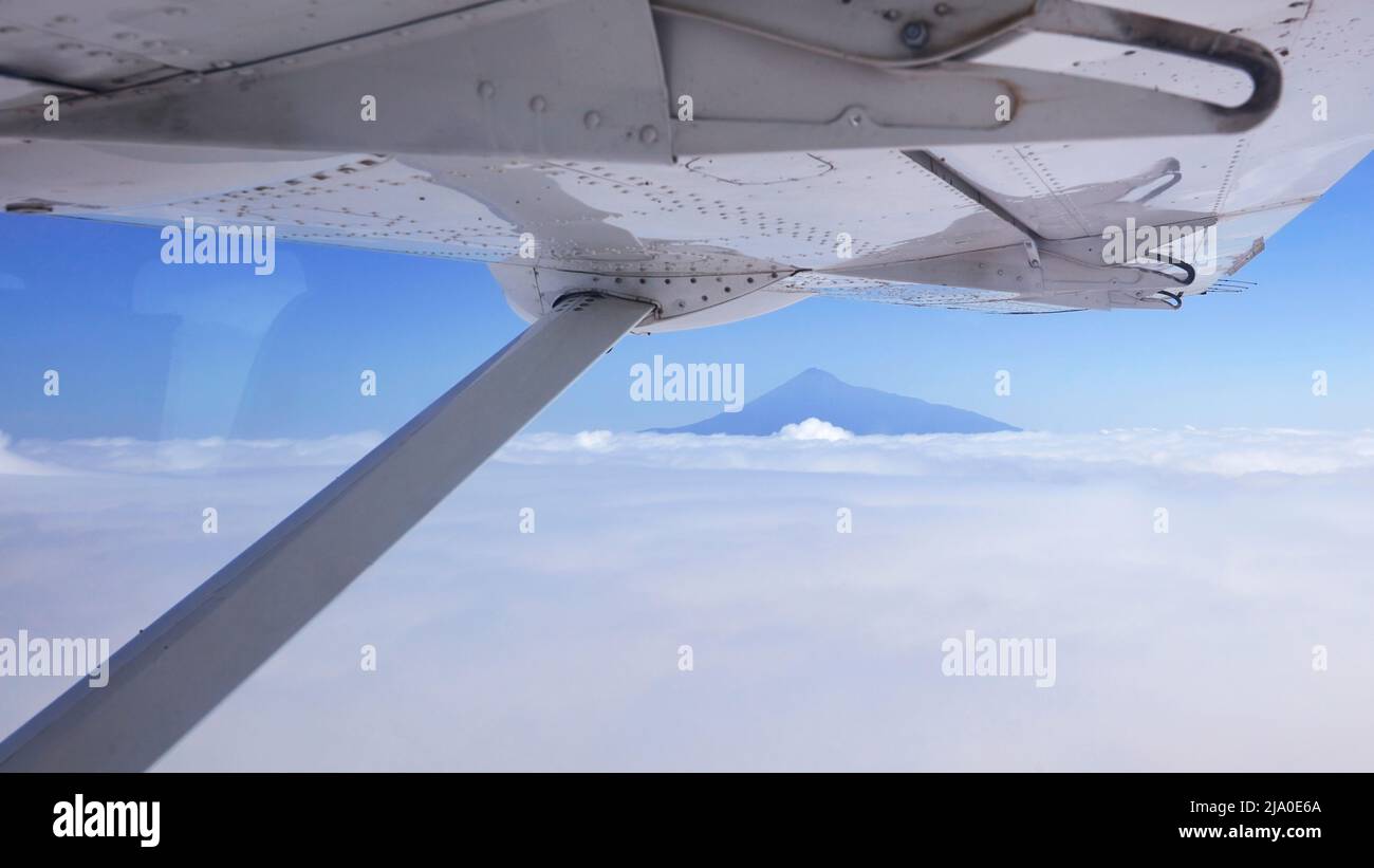 The top peak of Mount Meru is seen from a small charter flight airplane, Arusha, Tanzania. Stock Photo