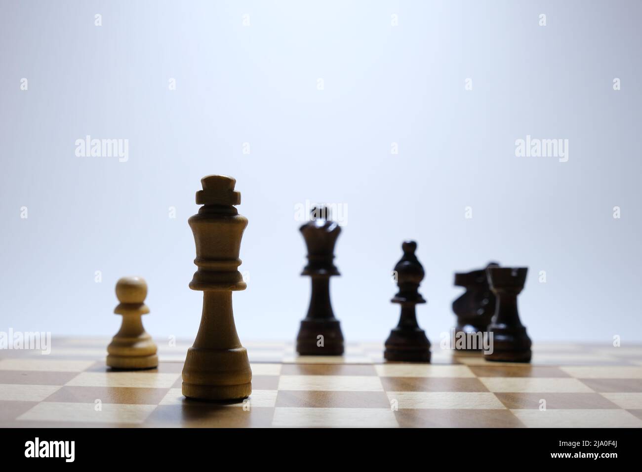 Checkmate concept. Chess board game concept background. Wood chess pieces on board game. Stock Photo