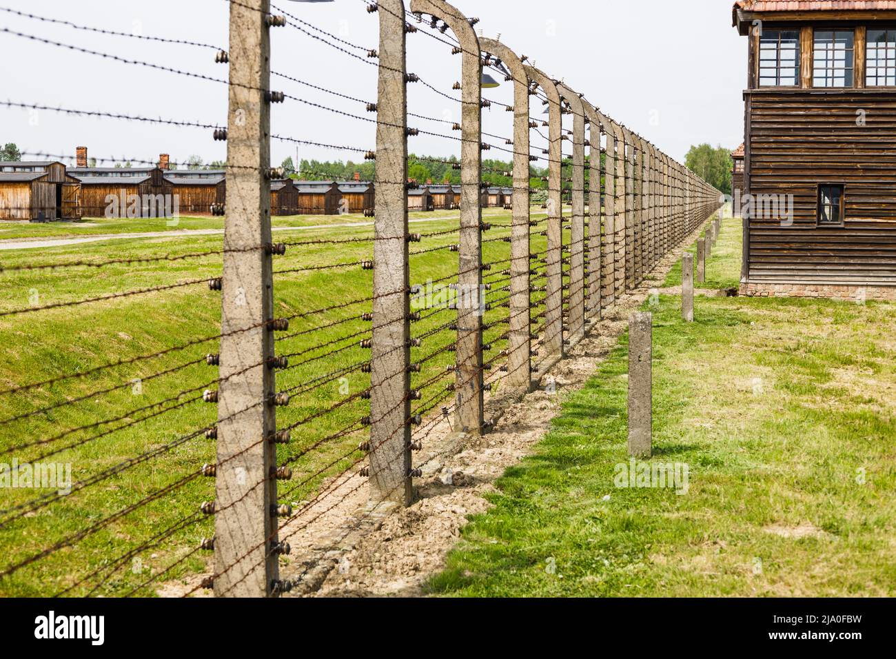 Barbed wire and guard towers around the Auschwitz-Birkenau concentration camp. Oswiecim, Poland, 16 May 2022 Stock Photo