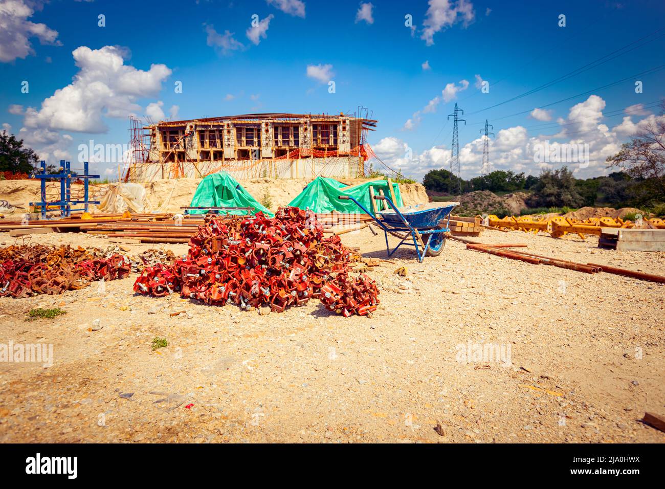 View on heap of disassembled steel scaffolding joint on construction site. Stock Photo