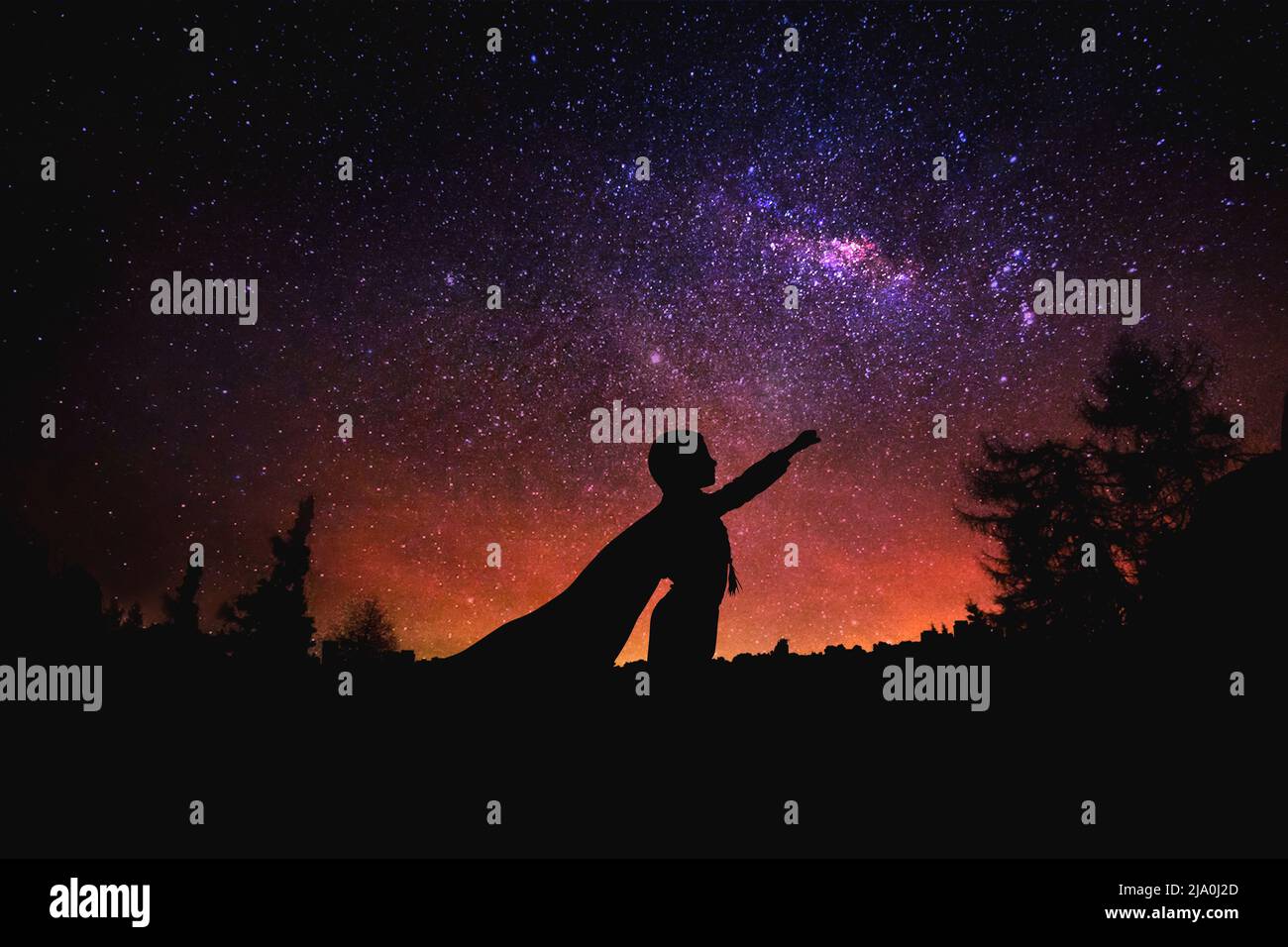 superhero at the night starry sky background. Mixed media Stock Photo