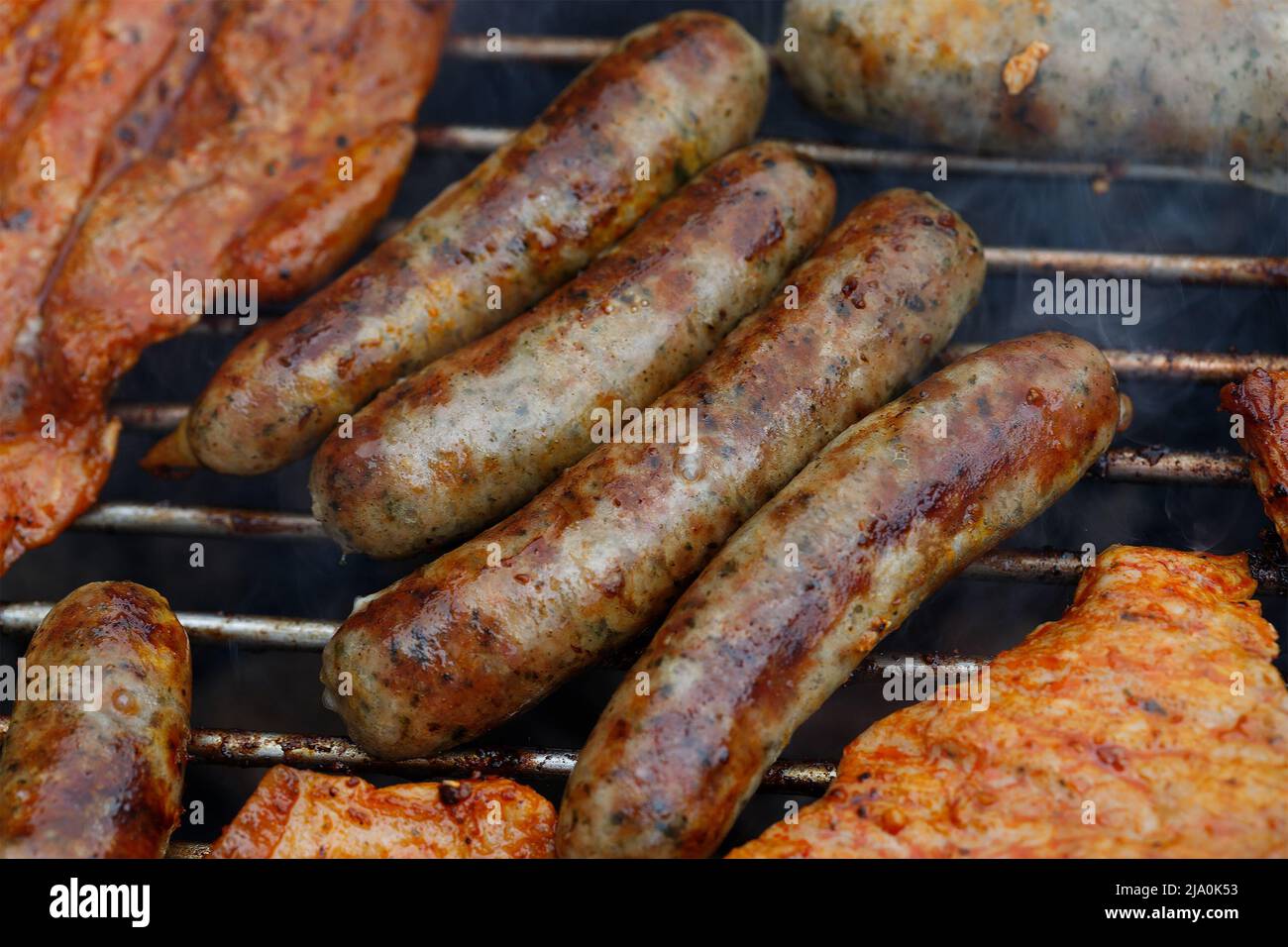 Grilled sausages on a grill. Barbecue food, grill, barbecue. Summer
