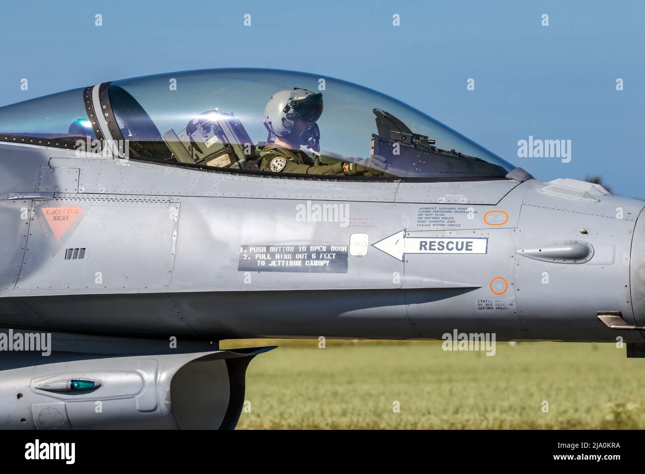 Pilot in the cockpit of a F-16 fighter jet plane taxiing towards the runway at Florennes Airbase. Belgium - June 15, 2017 Stock Photo