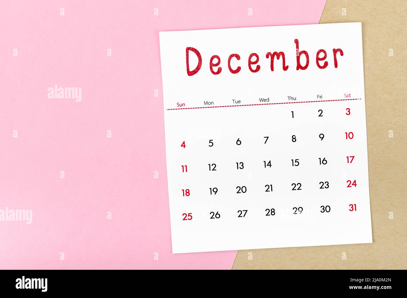 The December 2022 calendar on pink background with empty space. Stock Photo