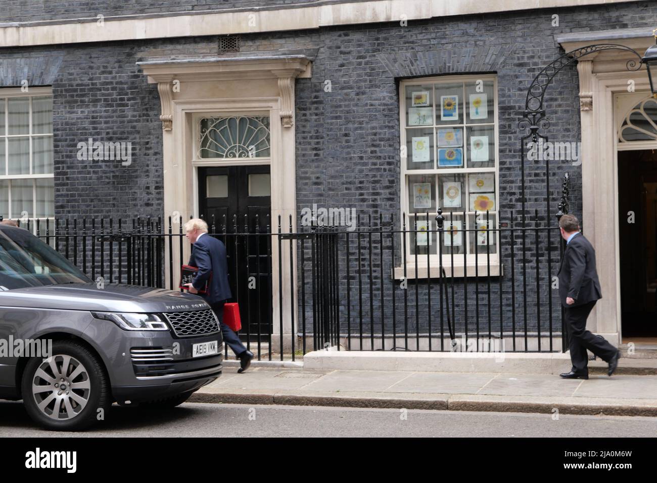 Boris Johnson leaves N10 with red briefcase today heading to Westminster as the Chancellor announces plans to give all households £400 of financial help as a grant to millions of people .It will be payed for by a windfall tax from energy companies making billions in profit  while millions of people in the UK are having to choose heating or eating as prices rise ..All households to get £400 in Autumn in a form off a grant that won't have to be repaid .Meanwhile Boris Johnson is getting pressure to quit over various parties held at N10 during  known as party gate after Sue Gray report . Stock Photo