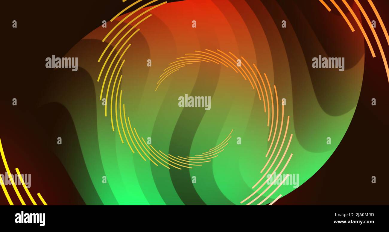 Image of spiral shapes in orange and green rotating on black background Stock Photo