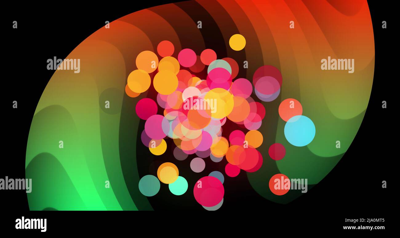 Image of colourful dots over spiral orange and green shapes on black background Stock Photo