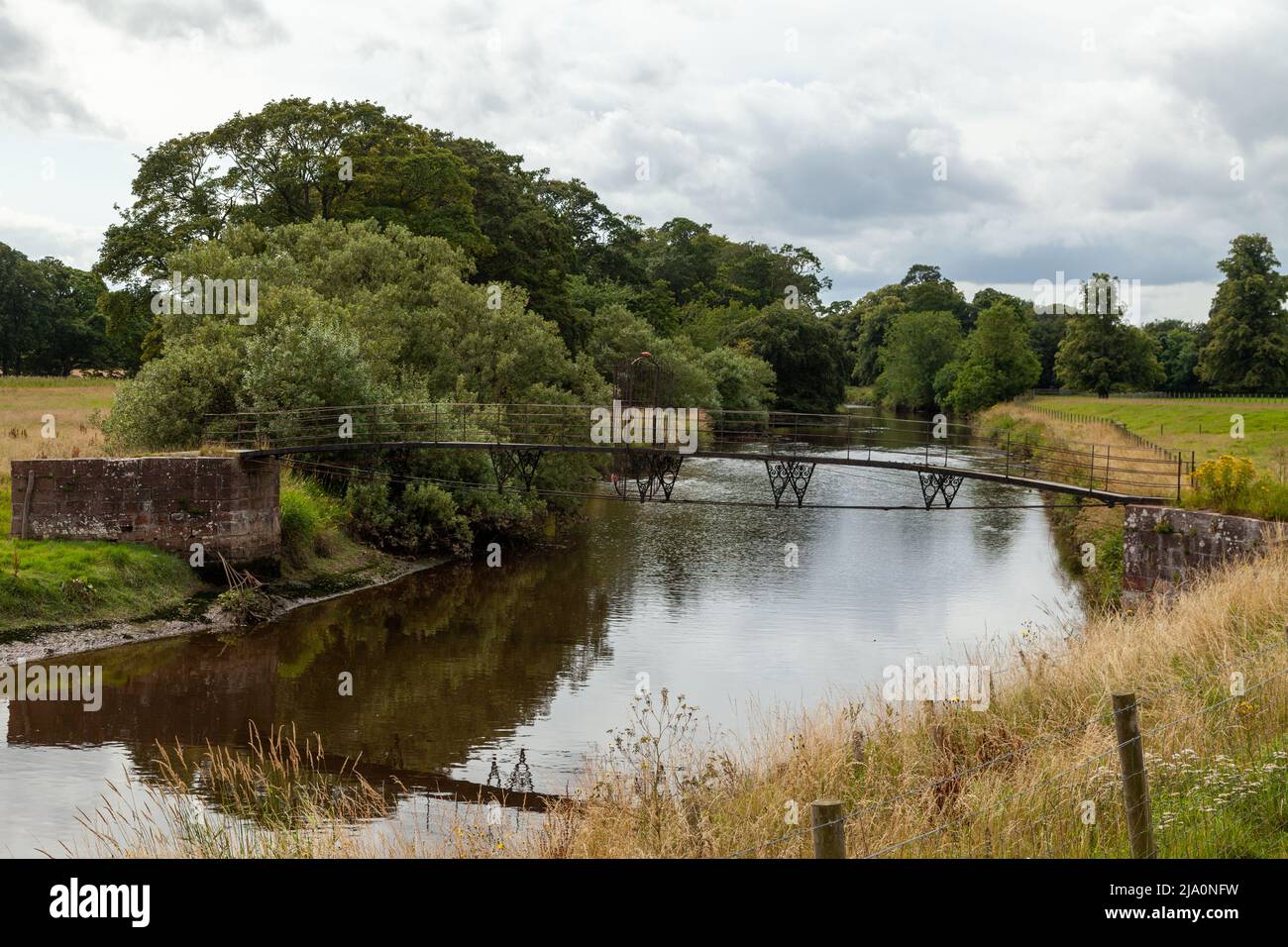 The old footbridge over the River Tyne in Tyninghame Estate, East Lothian. Stock Photo