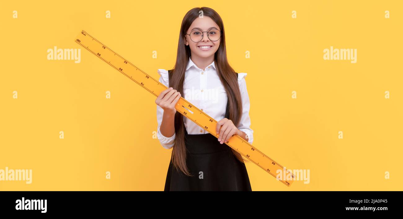 happy nerd kid in school uniform and glasses hold mathematics ruler for ...
