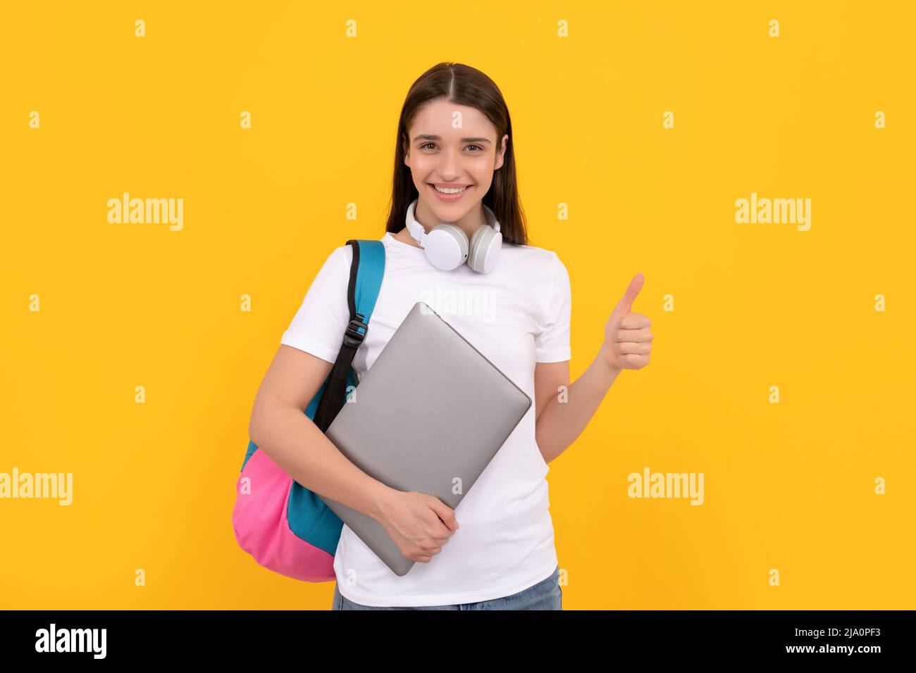woman with school bag hold laptop. buy online. back to school. thumb up. Stock Photo