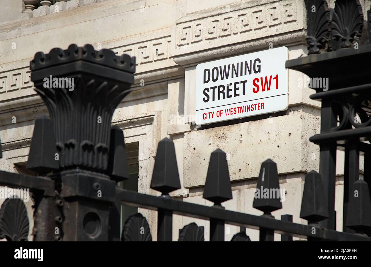 Enamelled Downing Street Sign SW1 Seen Through Metal Protective Fence Outside 10 Downing Street London Uk Stock Photo