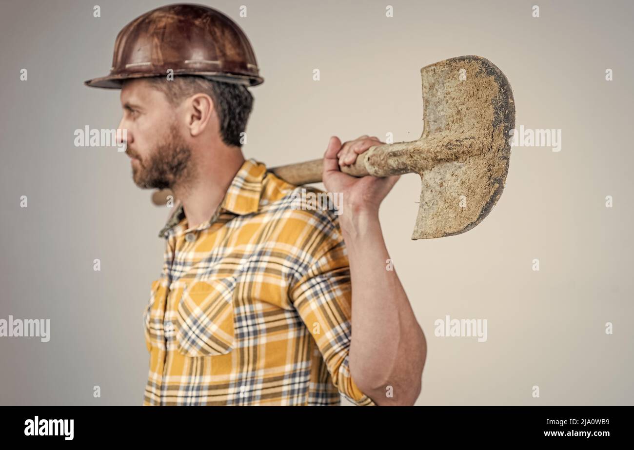 shovel in hand of man laborer. guy wear worker uniform. handsome ...