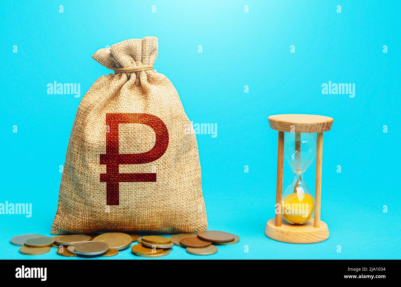 Russian ruble money bag and hourglass. Time for paying taxes. Pension savings. Customer loyalty program. Mortgage loan. Placing a deposit in the bank. Stock Photo