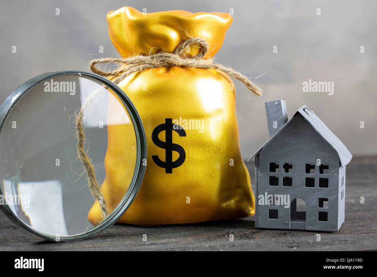 Magnifying glass, Money bag and house. buying a house concept Stock Photo