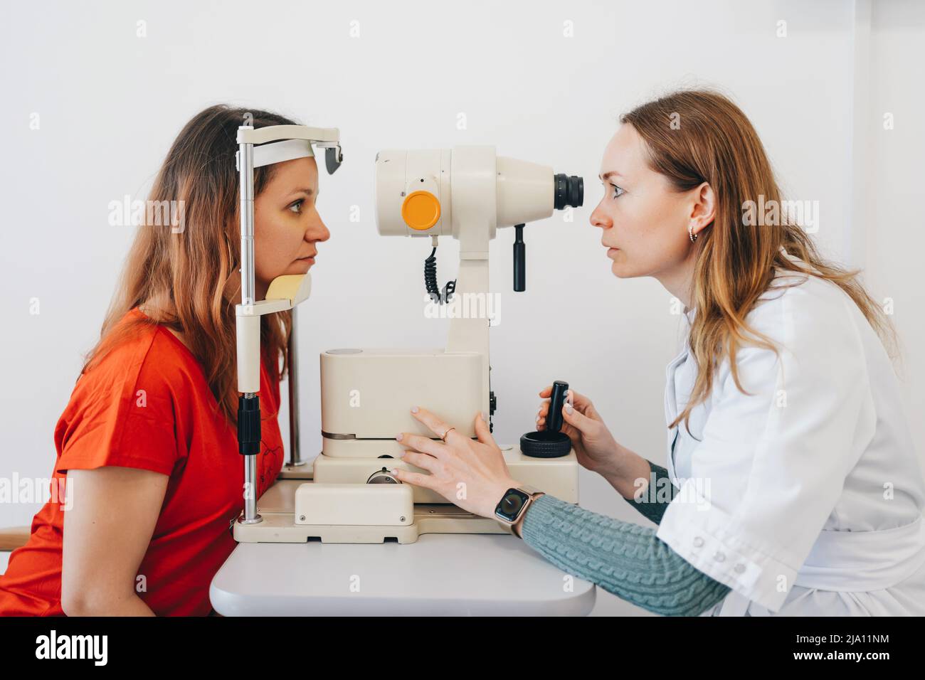 Eye test for visual acuity. The patient receives eye consultation. Stock Photo