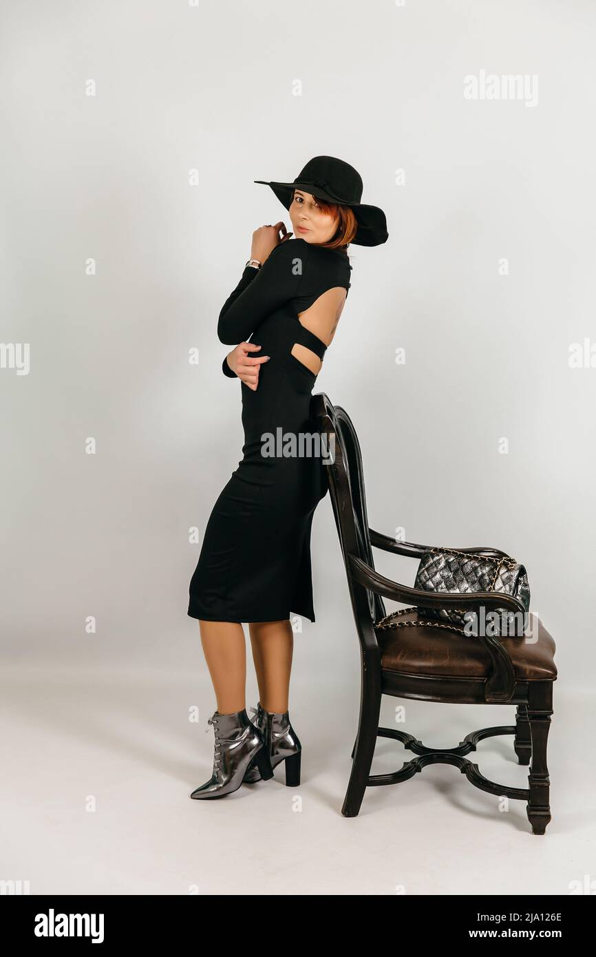 Pretty woman posing in studio Girl in a dress and hat Stock Photo - Alamy