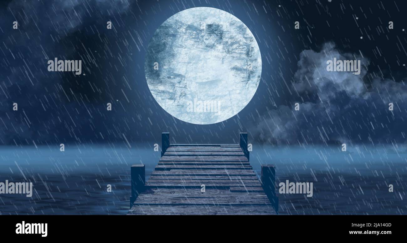 Image of wooden jetty over sea, rain and full moon on night sky in background Stock Photo