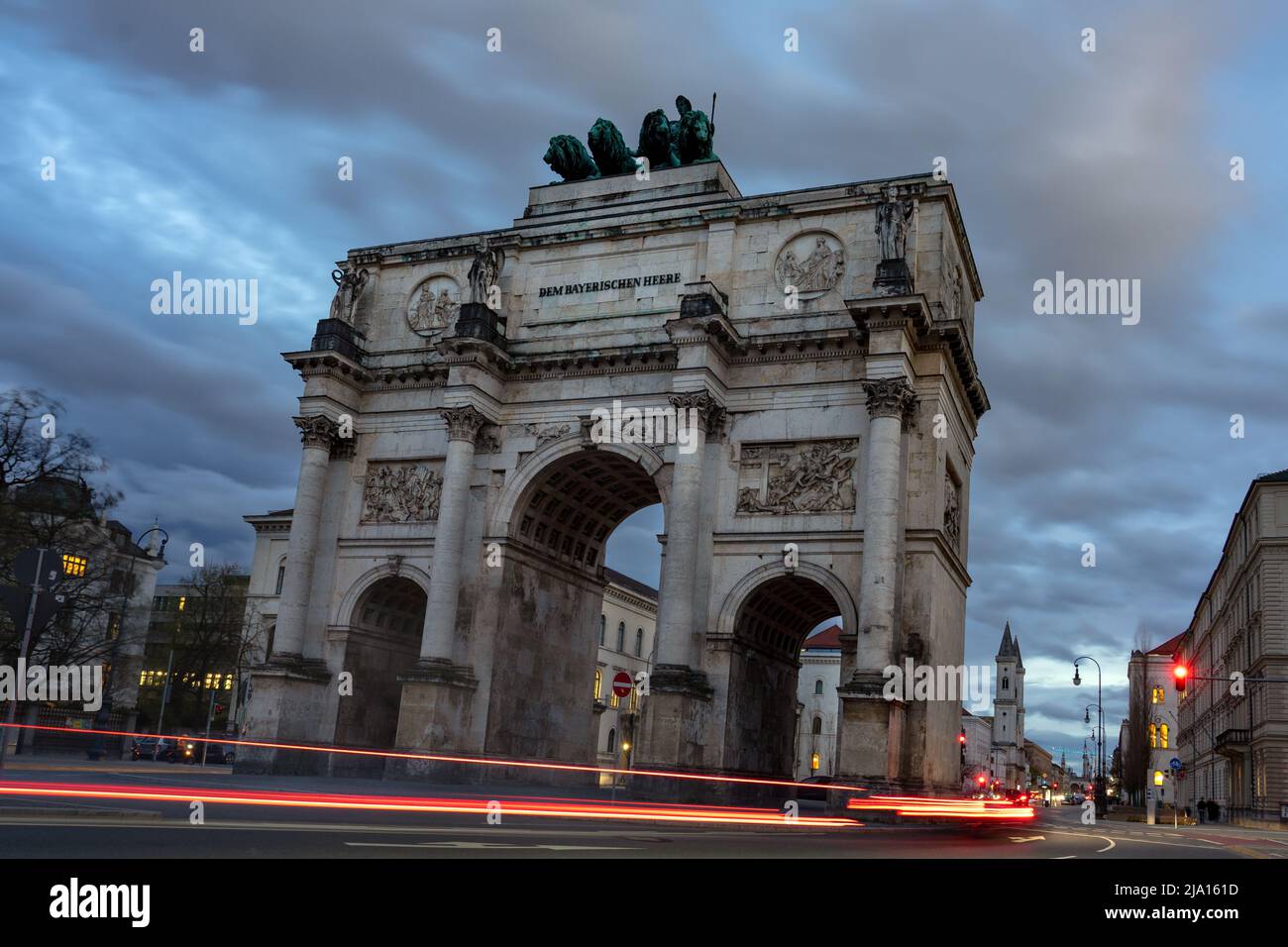 Victory gate Siegestor in Munich Germany with traffic lights in the evening Stock Photo