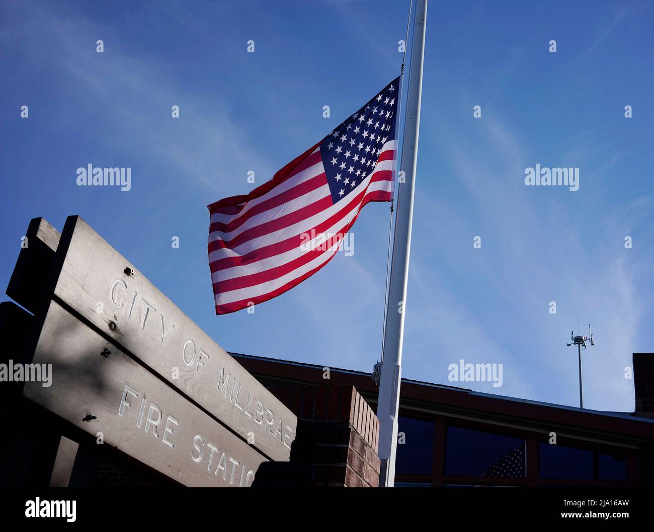 Millbrae, USA. 25th May, 2022. The U.S. flag flies at half-staff at a fire station in Millbrae, California, the United States, May 25, 2022. At least 19 children and two adults were killed in a shooting at Robb Elementary School in the town of Uvalde, Texas, on Tuesday. Credit: Li Jianguo/Xinhua/Alamy Live News Stock Photo