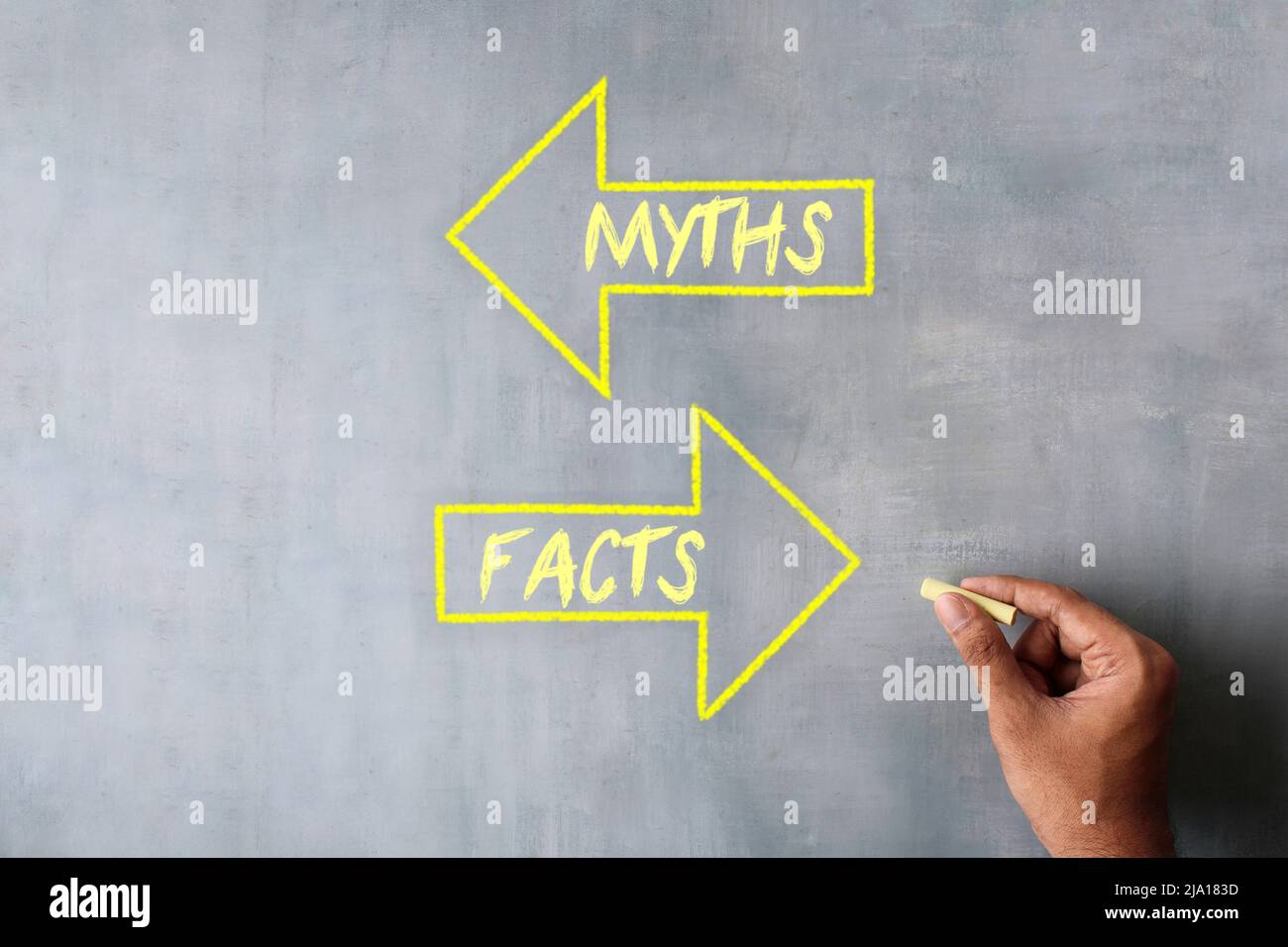 Hand draw arrow with text MYTHS and FACTS using chalk. Myths vs facts concept. Stock Photo