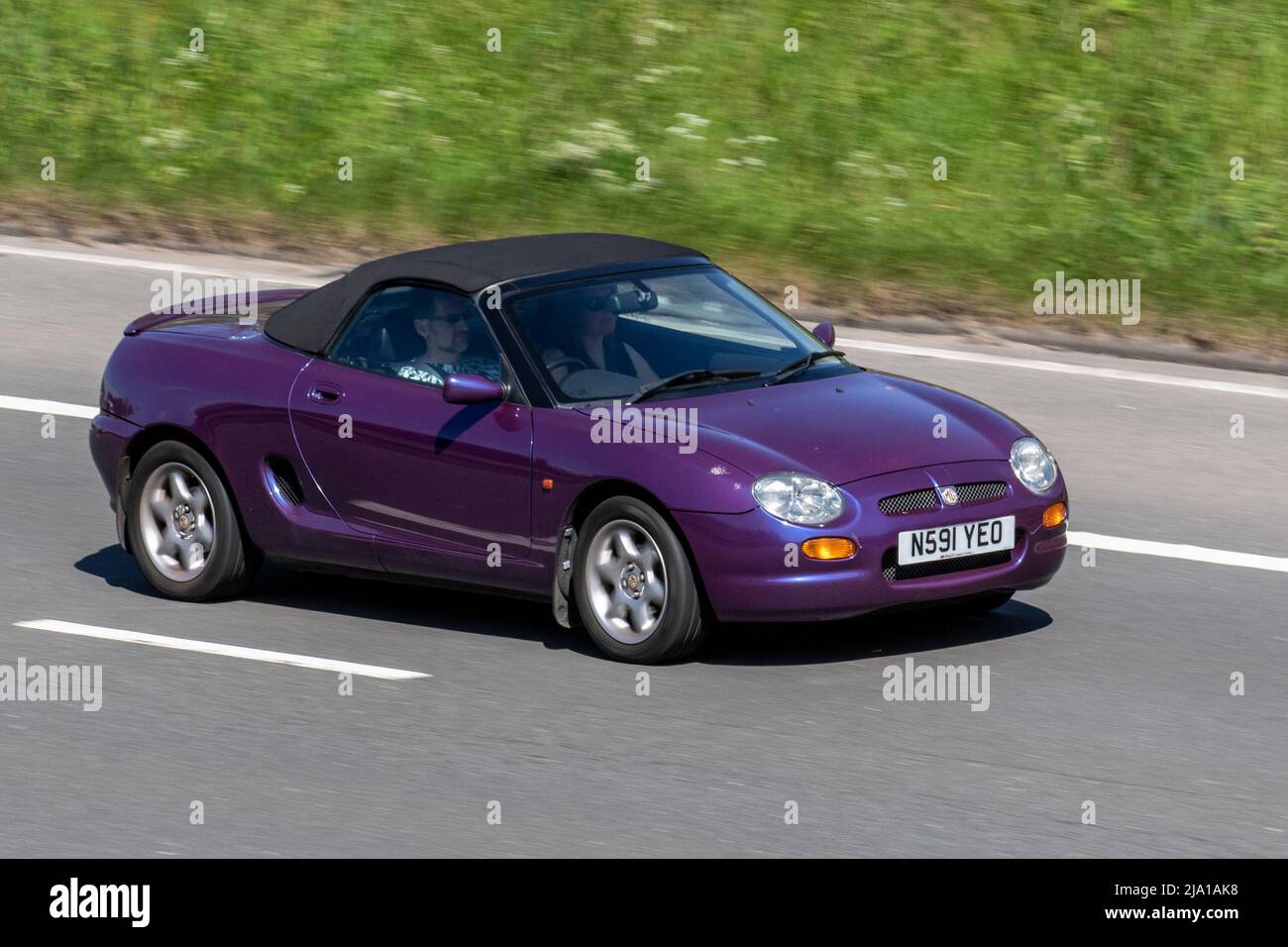 1996 90s nineties mauve purple Rover MGF 1800 cc petrol cabriolet; driving on the M61 near Manchester, UK Stock Photo