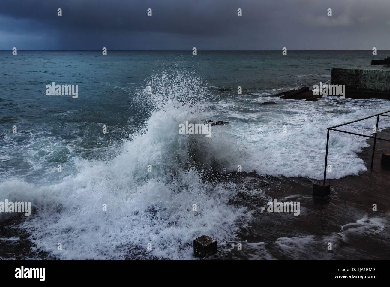 Storm at Black sea in spring. Sea view with waves during rain and cloudy in Alupka. Crimea Stock Photo