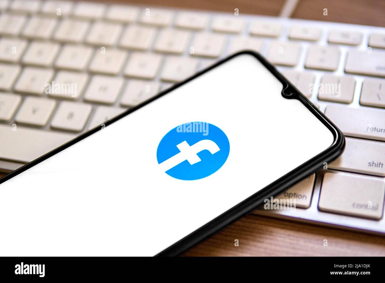 In this photo illustration, a Facebook logo seen displayed on a ...