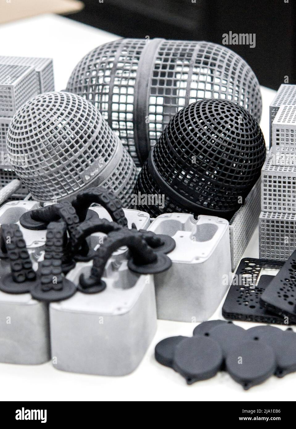 Many different objects printed on 3D printer from powder polyamide. Models printed on industrial 3D printer. Modern new prototyping technology. Additive automation manufacturing 3D printing technology Stock Photo