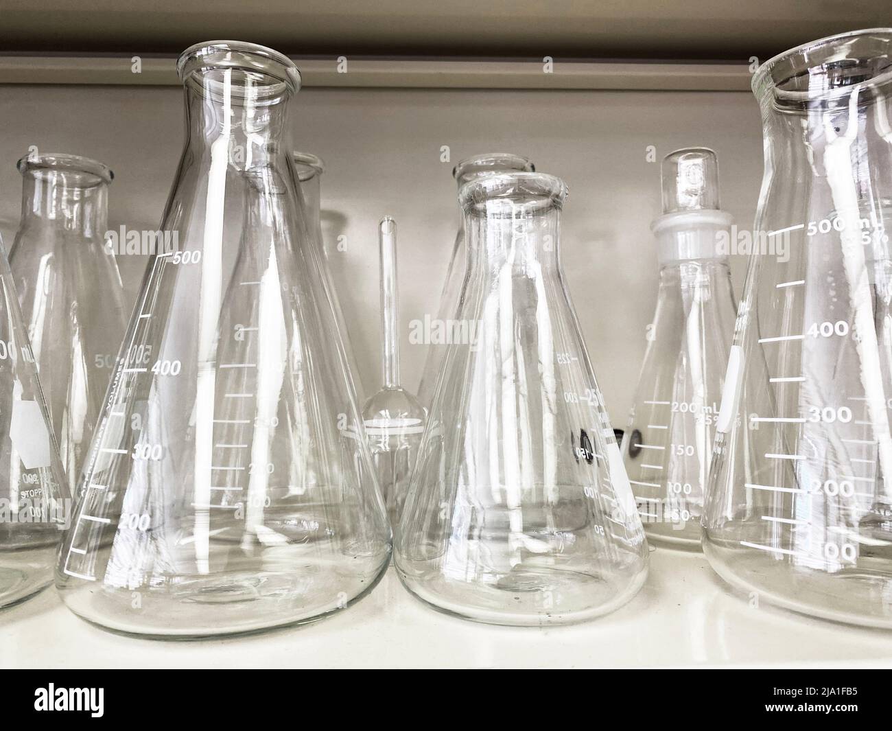 Laboratory glassware on a shelf. Erlenmeyer flasks in a lab Stock Photo Alamy