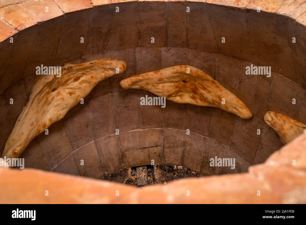 Closeup of Shoti bread baked in a traditional brick oven torn