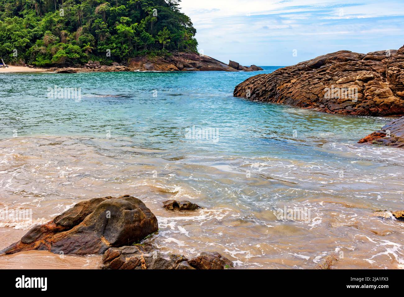 Untouched and deserted beach, surrounded by rainforest with calm, vividly colored waters in Trindade, municipality of Paraty, Rio de Janeiro Stock Photo