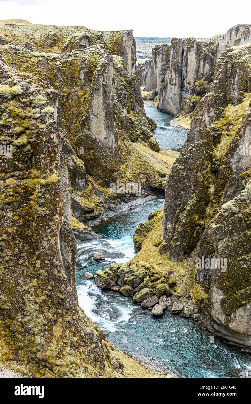 The canyon of Fjaðrárgljúfur is located near Kirkjubæjarklaustur, in Iceland. The canyon was formed by the river Fjaðrá. The river originates in the highlands and has dug up to 100 meters deep into the palagonite rock. Stock Photo
