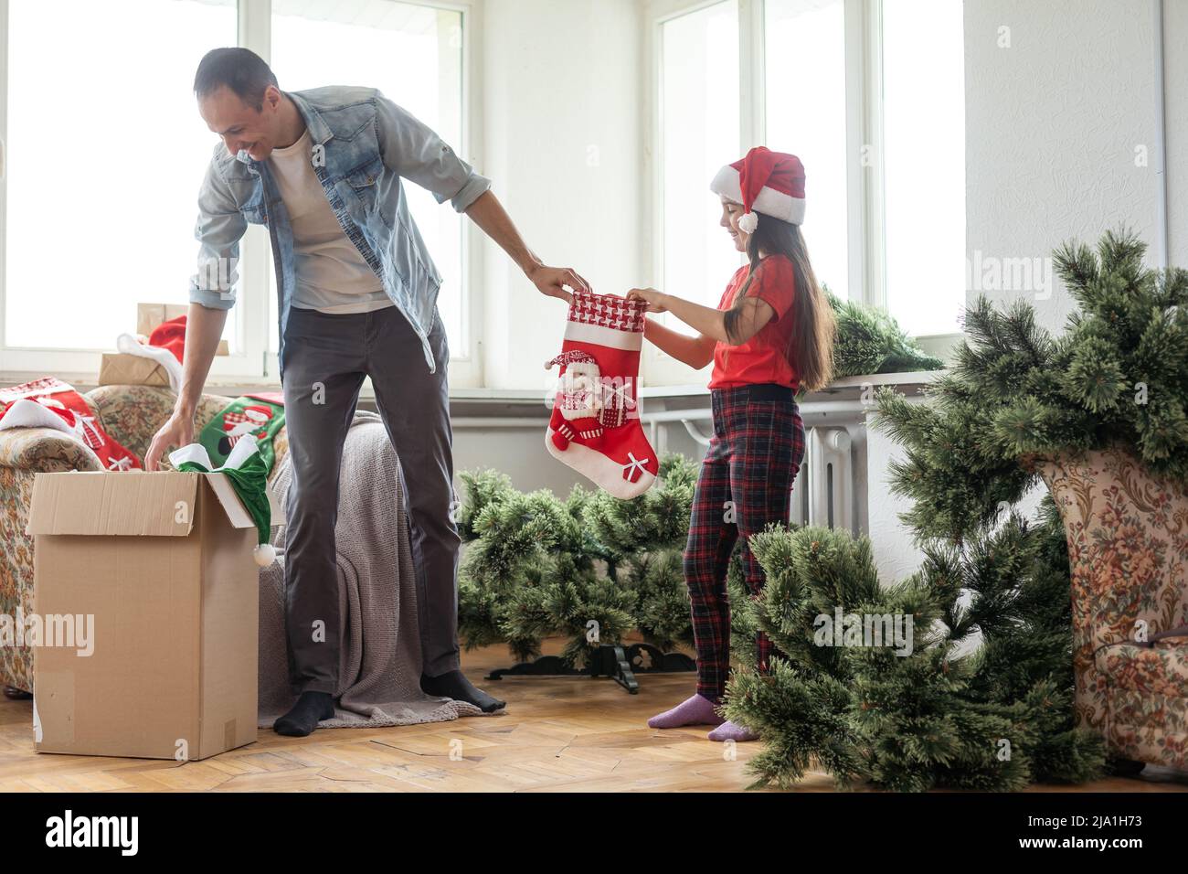 Father and daughter assembling christmas tree, smiling christmas