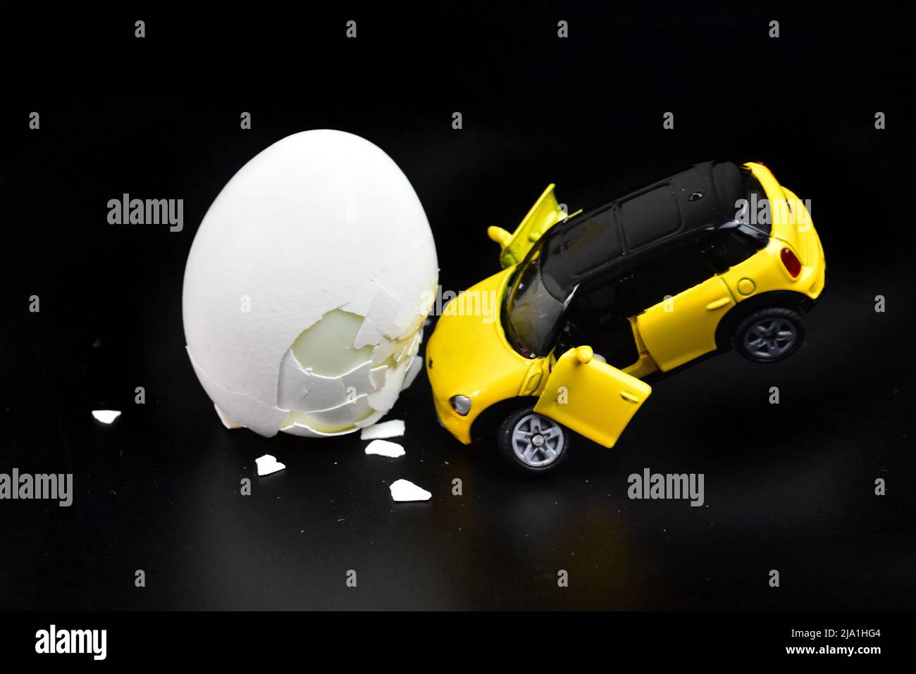 funny toy car accident with a chicken egg Stock Photo