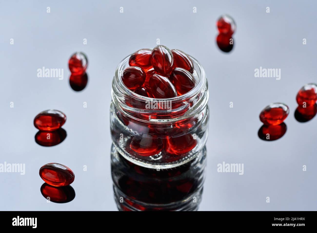 Krill oil pills or globules in a glass jar. - ealthy nutritional supplement rich in omega-3 fatty acids Stock Photo