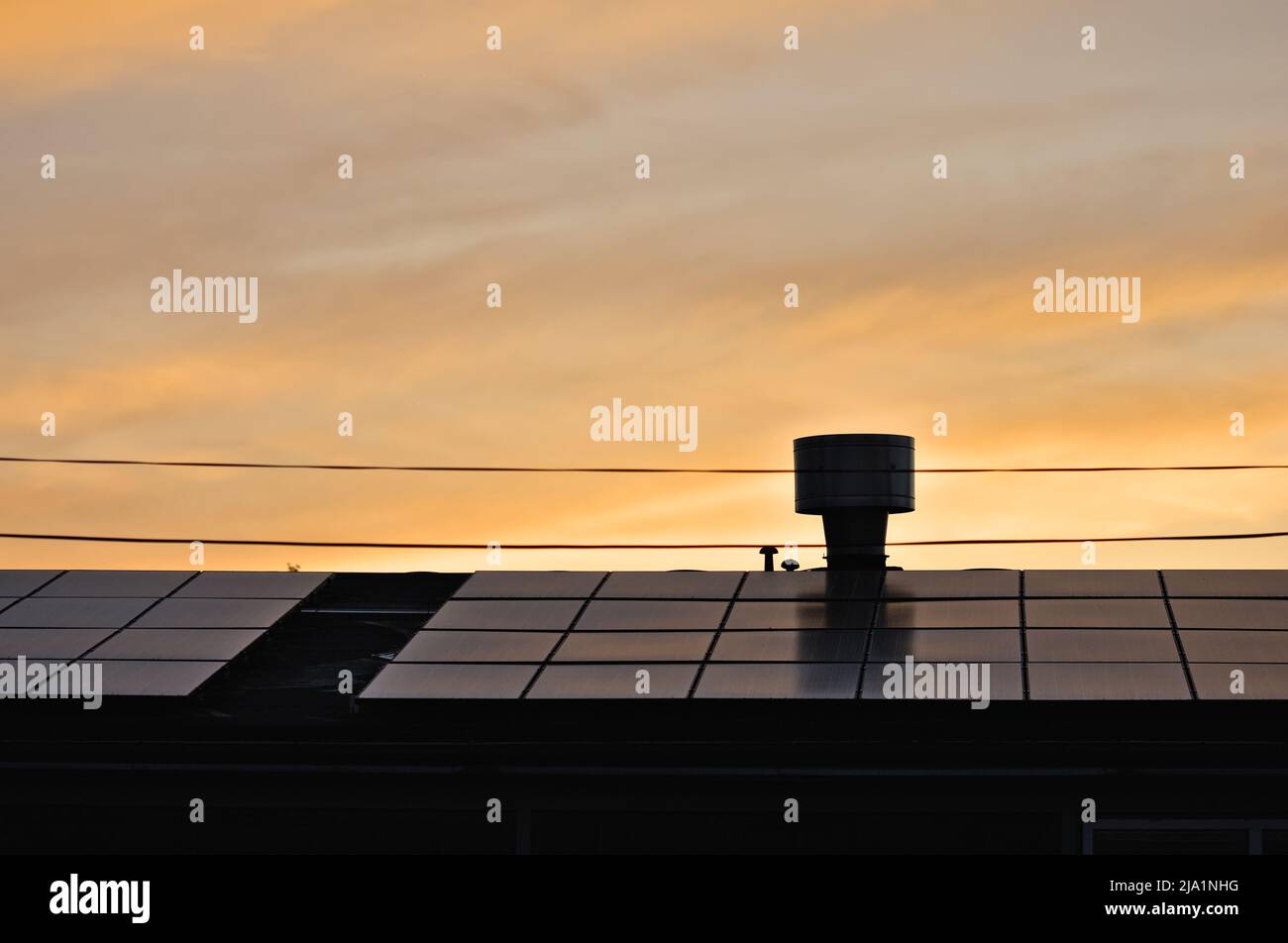 Solar panels on the roof of a house at sunset Stock Photo - Alamy