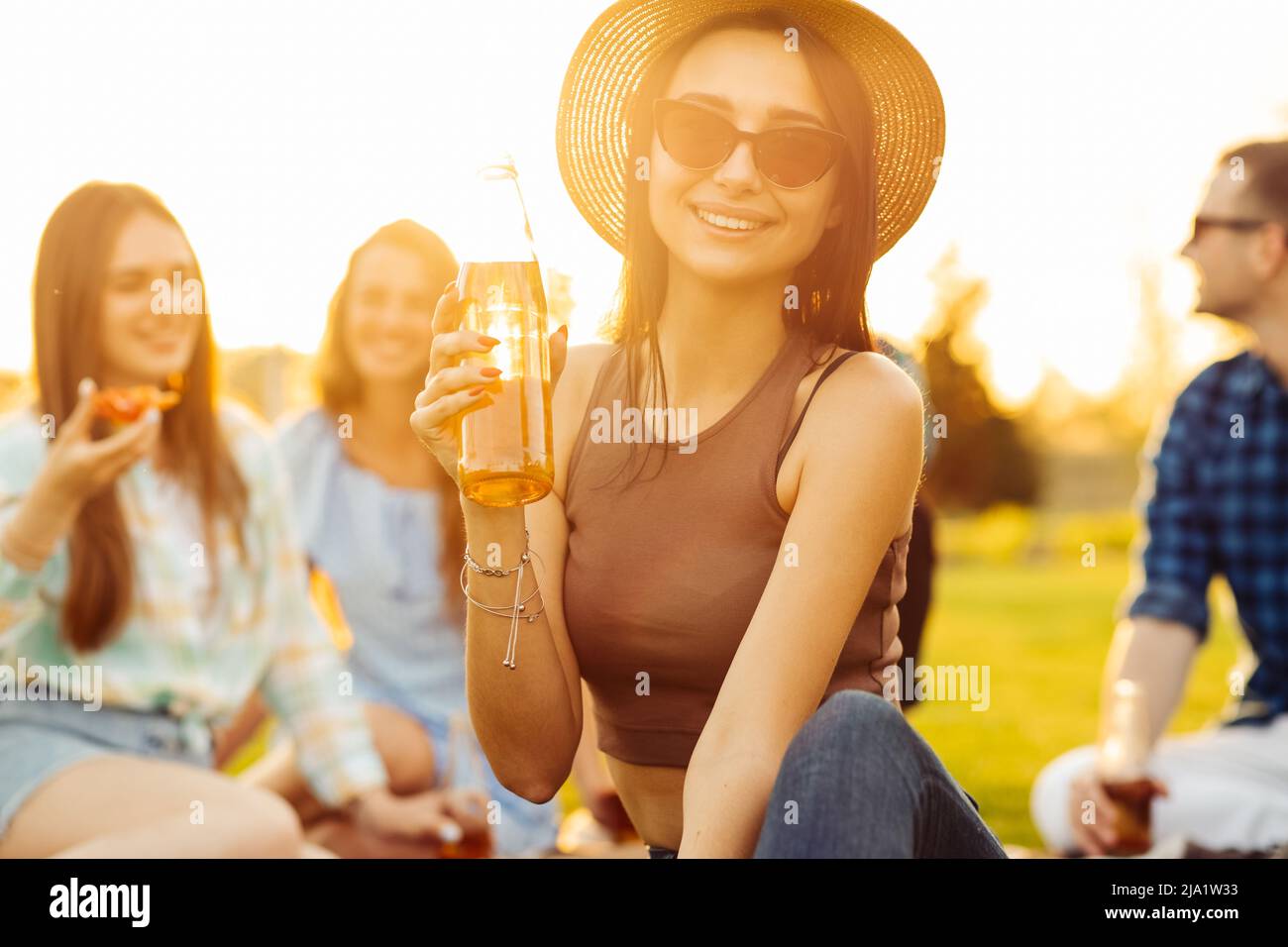 group of friends having a picnic in the park on a sunny day. A group of ...