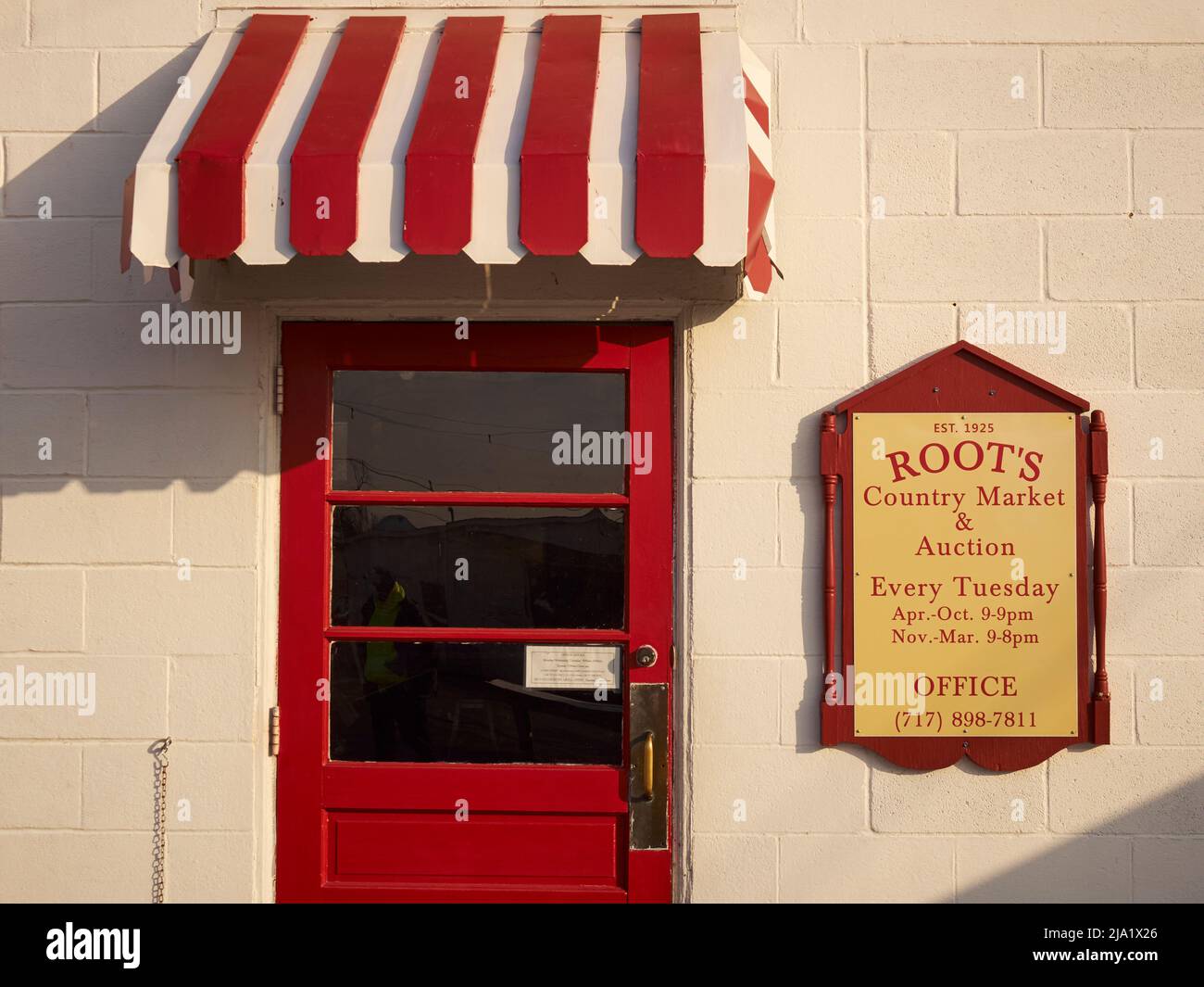 A red door entrance to Roots Market in Lancaster County, Pennsylvania, USA Stock Photo