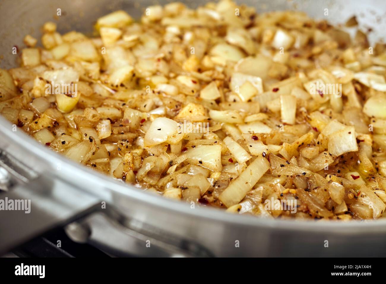 Onions caramelizing in a steel skillet Stock Photo Alamy