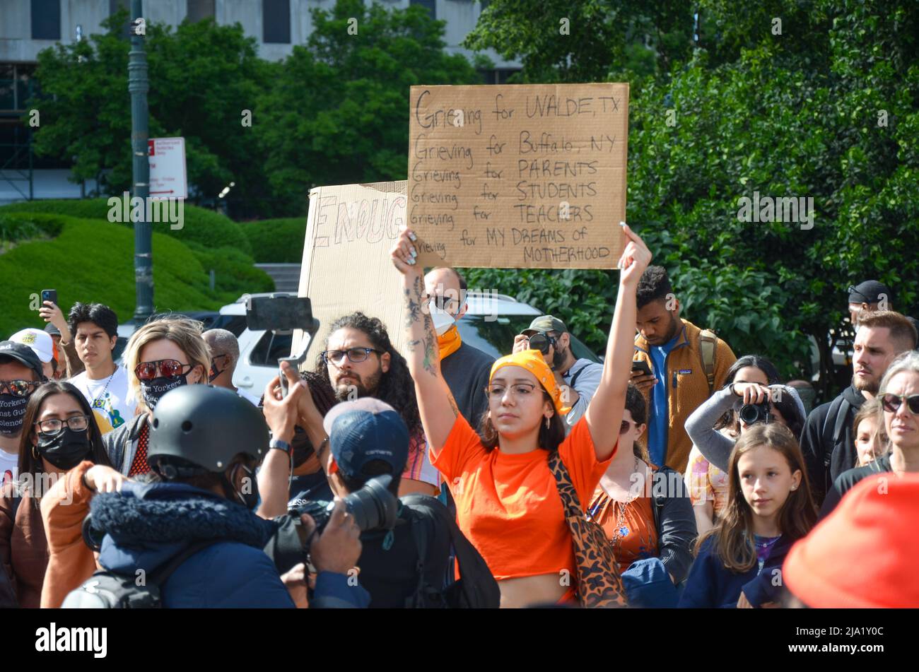 In solidarity with victims and survivors of the Buffalo, and Texas shootings, a participant is seen holding a sign at Foley Square in Lower Manhattan, Stock Photo