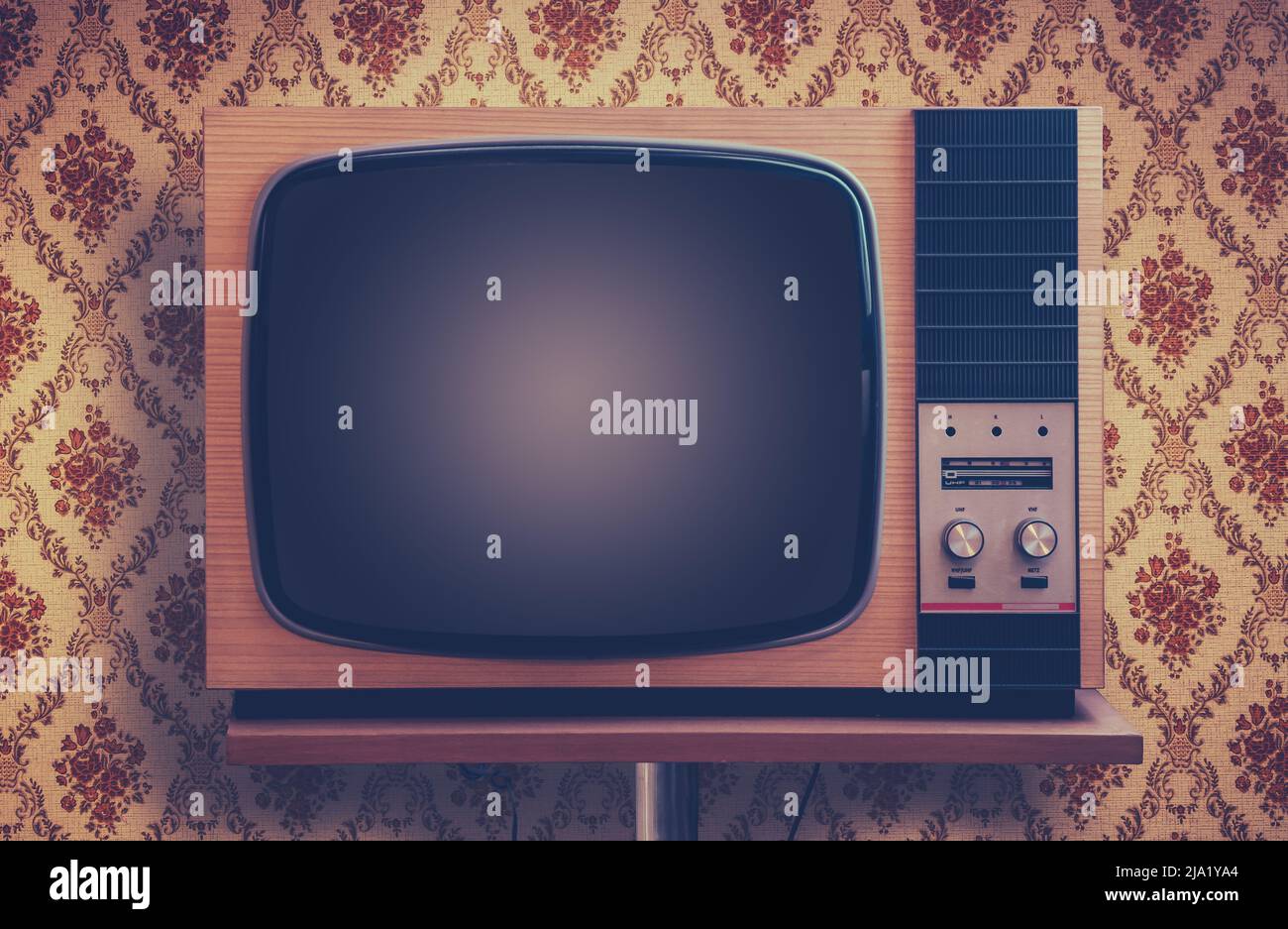 Retro TV In A Room With Ugly 1970s Vintage Wallpaper Stock Photo