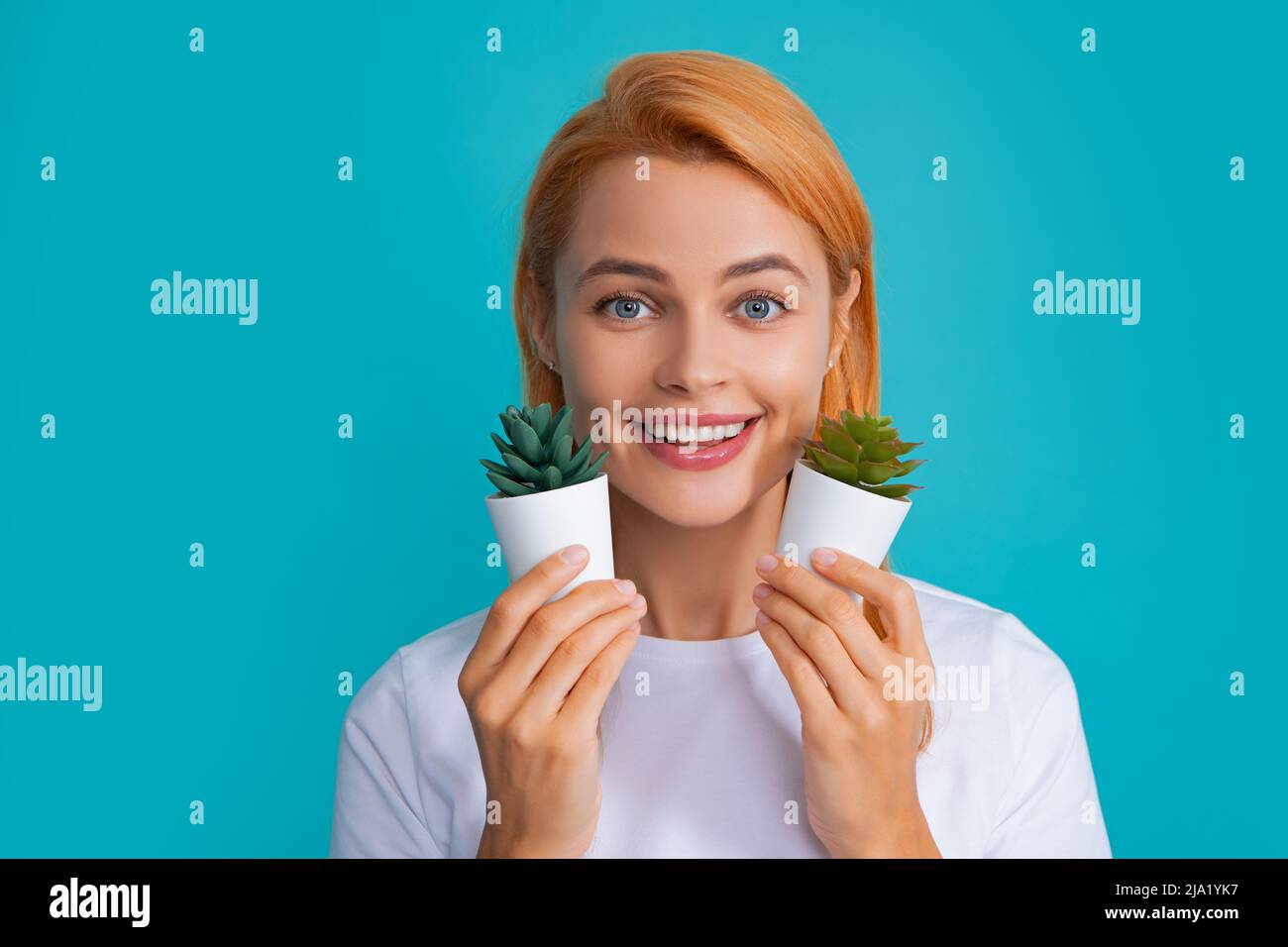  Beautiful woman holding small cactus, happy and smile Stock Photo - Alamy