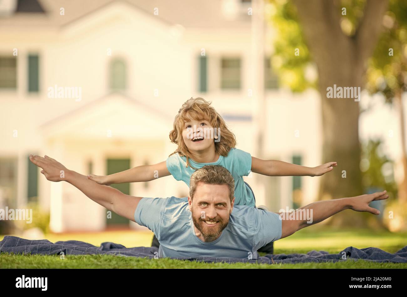 family value. childhood and parenthood. parent rest with little child boy on grass Stock Photo