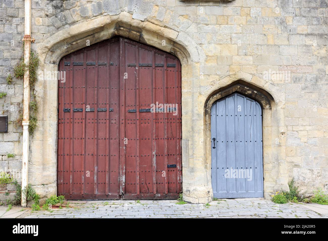 May 2022 - Anicent wooden doors in Wells, Somerset, England, UK Stock Photo